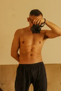 A man holding a camera up to his face